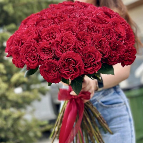 A close-up view of a vibrant bouquet of 50 roses, showcasing a variety of colors including red, pink, and white. The velvety petals and delicate fragrance of the roses evoke a sense of love and romance. The bouquet is expertly arranged and beautifully presented, making it an ideal gift for special occasions or expressions of affection.