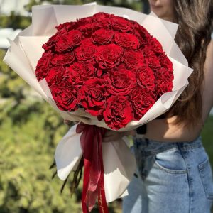 A close-up view of a vibrant bouquet of 25 roses, showcasing a variety of colors including red, pink, and white. The velvety petals and delicate fragrance of the roses evoke a sense of love and romance. The bouquet is expertly arranged and beautifully presented, making it an ideal gift for special occasions or expressions of affection.