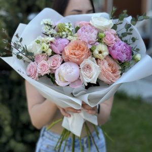 An enchanting garden bouquet featuring a captivating blend of peonies, roses, shrub roses, chamomile, Butterfly ranunculus, eucalyptus, and ornithogalum. The bouquet showcases a harmonious mix of colors, shapes, and textures, creating a visually stunning arrangement. Each flower contributes its unique charm, resulting in a truly mesmerizing display of natural beauty. Perfect for any occasion, this bouquet invites you to experience the enchantment of a bountiful garden.