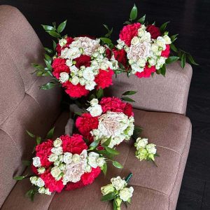 Bridal bouquet with roses and greenery. Bridesmaid bouquet with roses and greenery. Boutonniere with a single rose