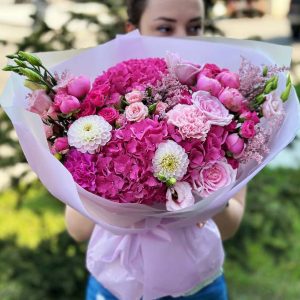 "Enchanted Garden Symphony" bouquet with hydrangeas, roses, dianthus, dahlias, lisianthus, spray roses, astilbe, and eucalyptus.