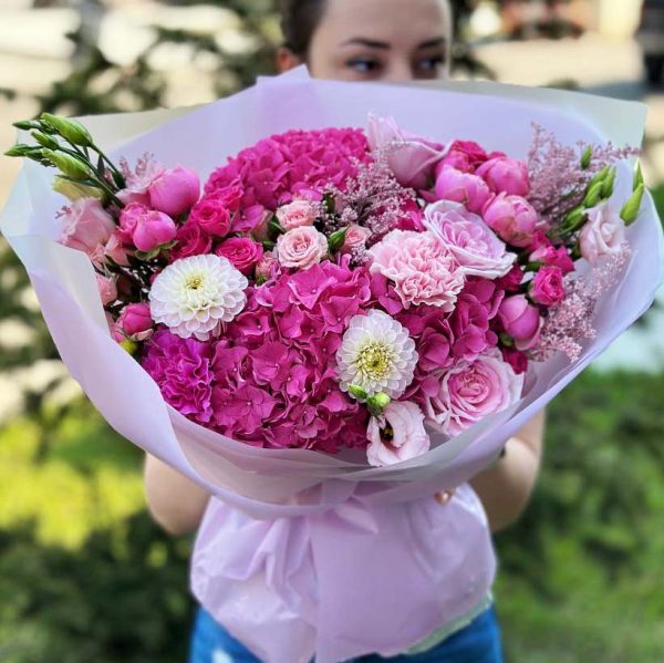 "Enchanted Garden Symphony" bouquet with hydrangeas, roses, dianthus, dahlias, lisianthus, spray roses, astilbe, and eucalyptus.