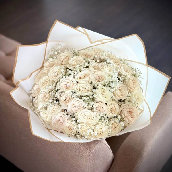 An enchanting bouquet of 36 roses accompanied by delicate gypsophila, also known as 'baby's breath'.