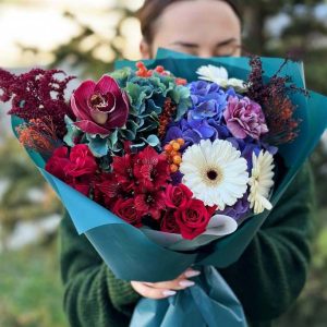 A captivating bouquet named "Harmony of Blooms and Orchids" showcasing hydrangeas, astromerias, dianthus, astilbes, orchids, spray roses, and viburnum berries in a vibrant and elegant arrangement.