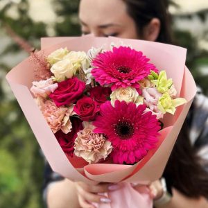 A colorful and vibrant bouquet showcasing spray roses, gerberas, lisianthus, dianthus, and astilbe, perfect for adding cheer to any occasion.