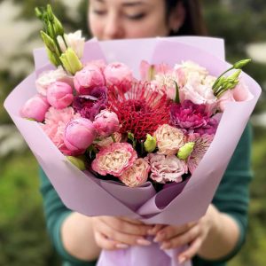 Bouquet featuring Leucospermum, spray roses, dianthus, astilbe, and lisianthus