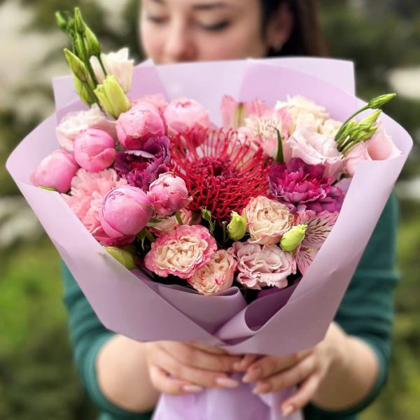 Bouquet featuring Leucospermum, spray roses, dianthus, astilbe, and lisianthus
