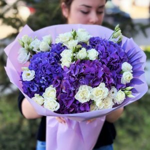 A close-up image of the "Heavenly Hydrangea Symphony" bouquet, showcasing the soft, abundant petals of hydrangeas, the tenderness of spray roses, and the timeless beauty of dried blooms.