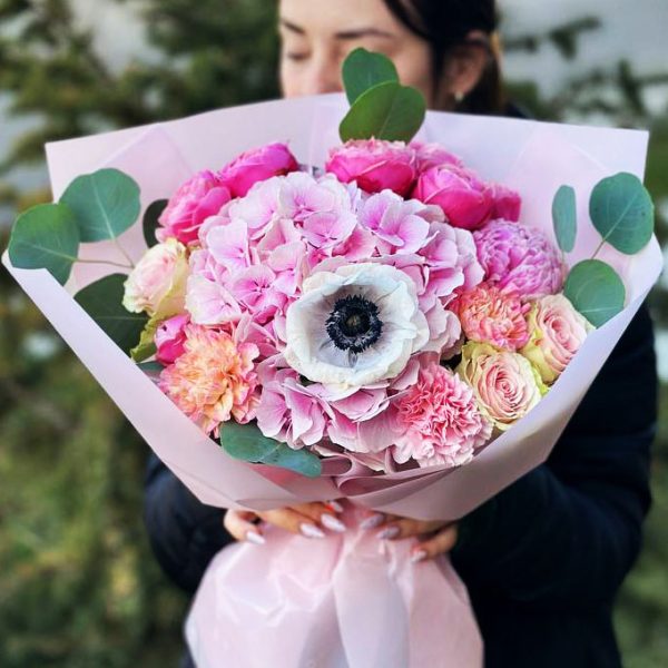 A close-up of the "Garden Elegance Bouquet" showcasing hydrangeas, anemones, spray roses, peonies, eucalyptus, and dianthus in a harmonious arrangement.