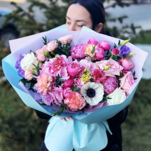 A close-up view of the "Whimsical Garden Melody" bouquet, featuring hydrangeas, anemones, roses, peonies, spray roses, dianthus, and lisianthus in a charming and whimsical arrangement.