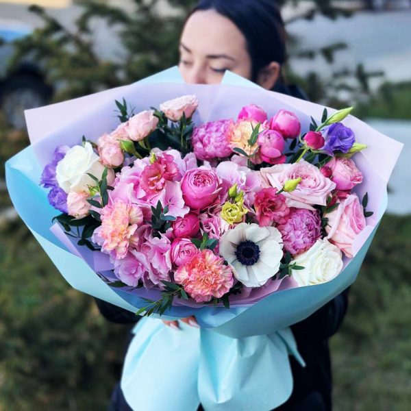 A close-up view of the "Whimsical Garden Melody" bouquet, featuring hydrangeas, anemones, roses, peonies, spray roses, dianthus, and lisianthus in a charming and whimsical arrangement.