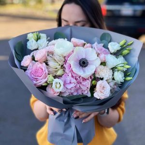 Image of the "Enchanted Garden Symphony" bouquet, a lush and romantic arrangement with hydrangeas, serruria, anemones, roses, and eucalyptus, ideal for celebrating life's beautiful moments.
