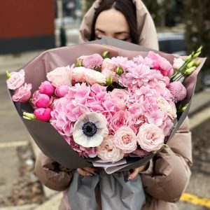 Image of the "Harmony in Blooms" bouquet featuring hydrangeas, anemones, spray roses, chrysanthemums, and lisianthus – a symbol of grace and unity.
