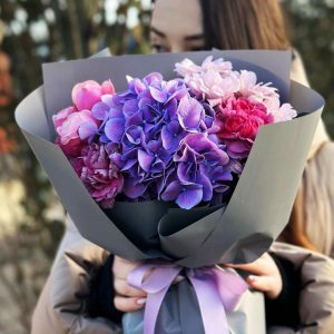 Image of the "Harmony in Bloom" bouquet, showcasing a stunning arrangement of hydrangeas, dianthus, spray roses, and chrysanthemums. The varied colors and textures create a visual symphony, making it a perfect choice for weddings and special occasions.