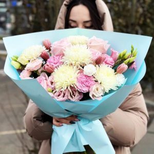 Image of the "Harmonious Floral Symphony" bouquet, showcasing a vibrant arrangement of chrysanthemums, roses, lisianthuses, tulips, dianthuses, and spray roses. The varied colors and textures create a harmonious and visually stunning floral ensemble.