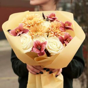 An image of the "Eternal Elegance Trio" bouquet showcasing a beautiful arrangement of roses, tulips, and chrysanthemums. The classic and modern blooms come together in a harmonious display of timeless elegance.