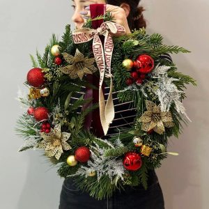 Festive Splendor: Christmas wreath with pine, red, and gold ornaments, creating a festive atmosphere and adding elegance to your space.