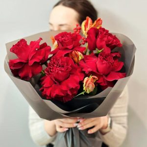 Spring Blossom Trio: A delightful arrangement showcasing roses, ilex, and tulips, creating a fresh and vibrant spring display.