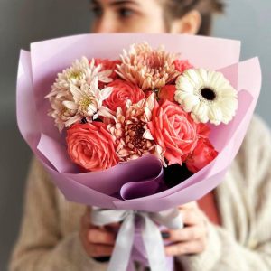 Radiant Blooms Trio: A captivating arrangement showcasing the delicate allure of spray roses, the timeless beauty of chrysanthemums, and the vibrant charm of gerbera.