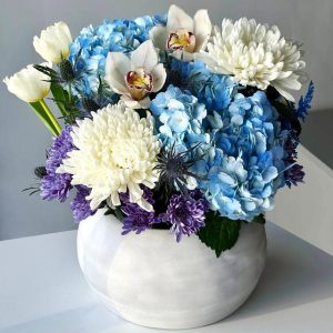 Eternal Harmony: A stunning vase arrangement showcasing hydrangea, chrysanthemums, tulips, orchids, eryngium, and solidago, creating a perfect balance of beauty and diversity.