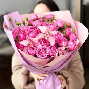 Serenity Blooms: A harmonious arrangement showcasing the delicate charm of spray roses and the exotic allure of orchids, radiating serenity and sophistication.