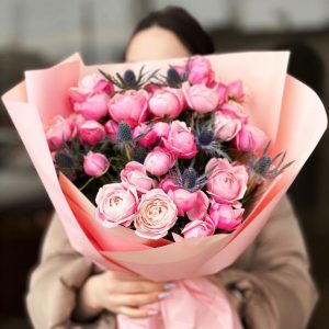 Mystic Bloom Duo: A captivating arrangement featuring the delicate allure of spray roses and the enchanting beauty of eryngium, sparking curiosity and admiration.