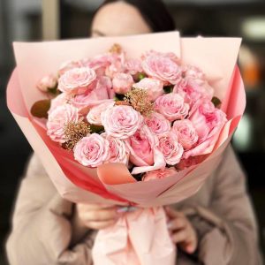 Rose Symphony: A harmonious arrangement showcasing the timeless elegance of roses, the delicate charm of spray roses, and the lush greenery of skimmia.