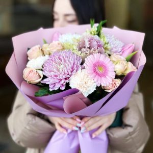 Spring Symphony Bouquet: A vibrant arrangement showcasing chrysanthemums, gerbera daisies, tulips, dianthus, spray roses, brassica, and astrantia, capturing the lively essence of spring.