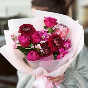 Red Flash arrangement featuring roses, gerberas, proteas, astromerias, and wax flowers