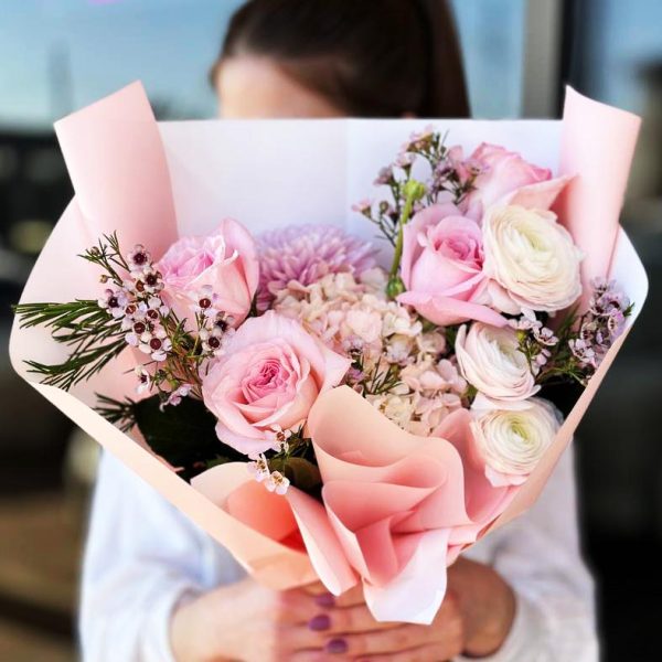 Spring Blossom Delight bouquet featuring roses, hydrangeas, ranunculus, chrysanthemums, and wax flowers