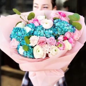Enchanting Garden Harmony Bouquet featuring hydrangeas, roses, spray roses, dianthus, ranunculus, and eucalyptus