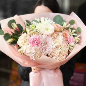 Whispering Petals Bouquet showcasing hydrangeas, chrysanthemums, spray roses, astromerias, ranunculuses, dianthuses, and eucalyptus.