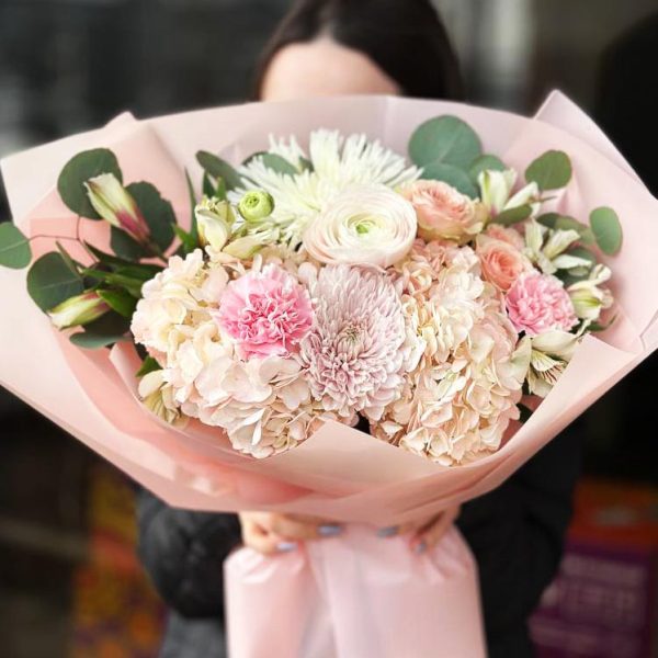 Whispering Petals Bouquet showcasing hydrangeas, chrysanthemums, spray roses, astromerias, ranunculuses, dianthuses, and eucalyptus.