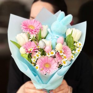 Playful Blooms Bouquet showcasing toys, gerberas, tulips, and daisies for a cheerful and vibrant display.