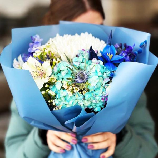 Spring Blossom Symphony Bouquet featuring hydrangeas, chrysanthemums, alstroemerias, wax flowers, tulips, delphiniums, and eryngiums for a vibrant and elegant display.