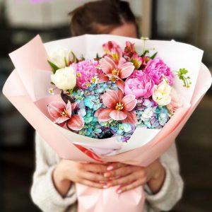 Spring Garden Harmony Bouquet showcasing hydrangeas, tulips, alstroemerias, peonies, and daisies for a fresh and joyful display.