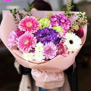 Elegant Garden Harmony Bouquet showcasing hydrangeas, chrysanthemums, gerberas, spray roses, viburnum, eucalyptus, and skimmia for a visually stunning and aromatic display.