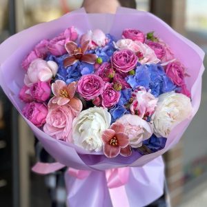 An elegant Moon Symphony flower bouquet featuring a harmonious arrangement of moonlit blooms in soft, serene colors, beautifully presented in a stylish vase.