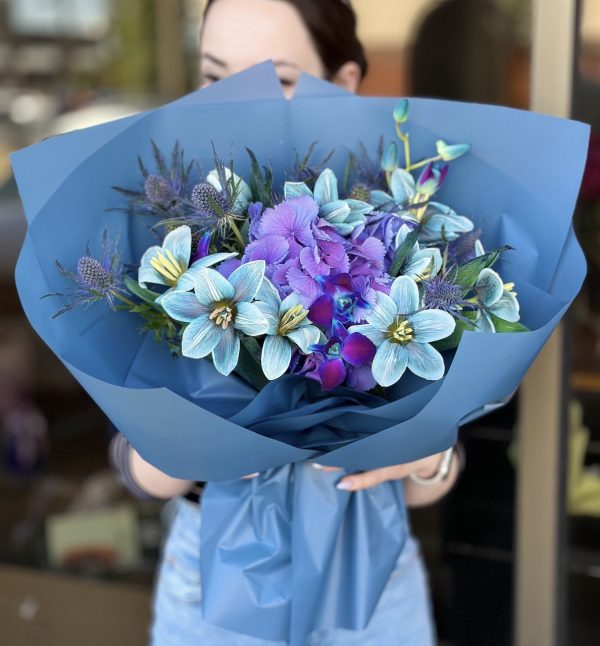Image of 'Magic Flowers' bouquet showcasing a delightful blend of hydrangeas, eryngium, tulips, and dendrobium orchids, perfect for adding enchantment to any setting.