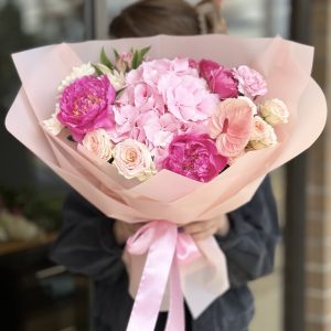 Beautiful floral bouquet featuring a variety of vibrant blooms and lush greenery, perfect for special occasions.