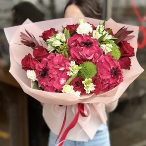 Beautiful bouquet 'Garden Delights' featuring a variety of seasonal blooms and lush green foliage, perfect for weddings and special occasions.
